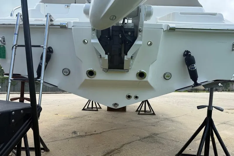 Slide: The Image of 2026 Key West 219 FS boat stern view with ladder and support stands. - 4