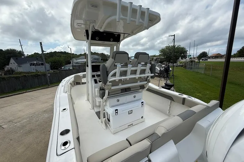 Slide: The Image of 2026 Key West 219 FS boat with seating and storage, parked outdoors under cloudy skies. - 6