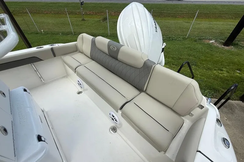 Slide: The Image of 2026 Key West 219 FS boat interior with beige seating and speakers. - 7