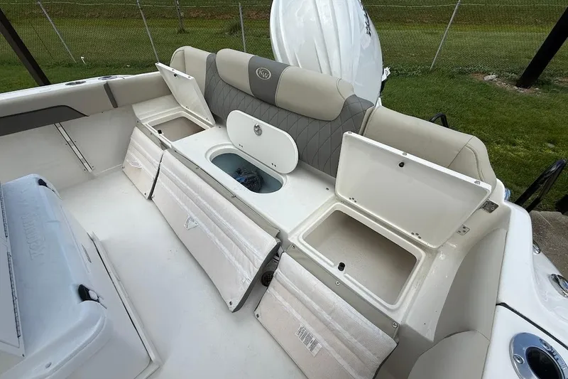 Slide: The Image of 2026 Key West 219 FS boat interior with open storage compartments and seating. - 8
