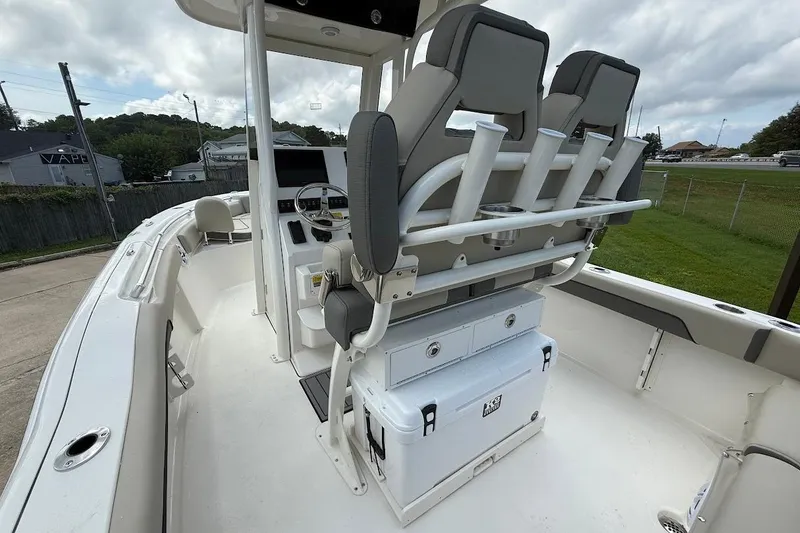 Slide: The Image of 2026 Key West 219 FS boat interior with seating and storage, under cloudy sky. - 9