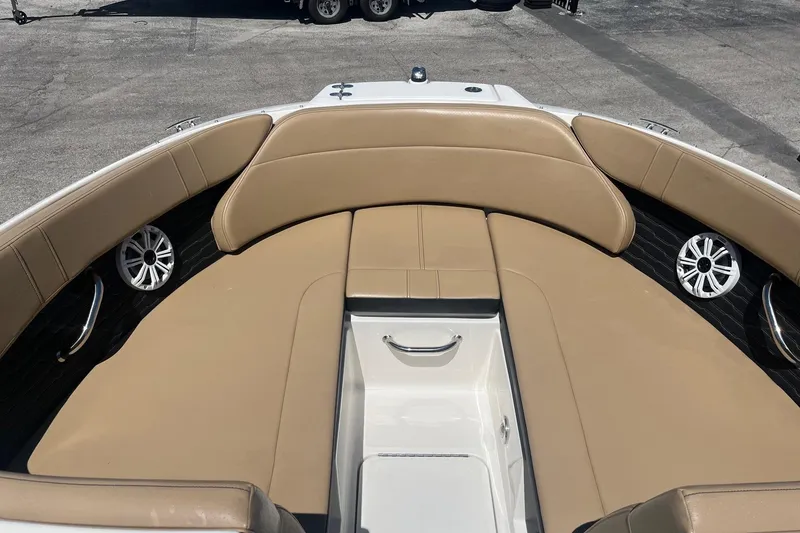 Slide: The Image of 2024 Sea Ray SPX 230 boat interior with tan seating and speakers. - 10
