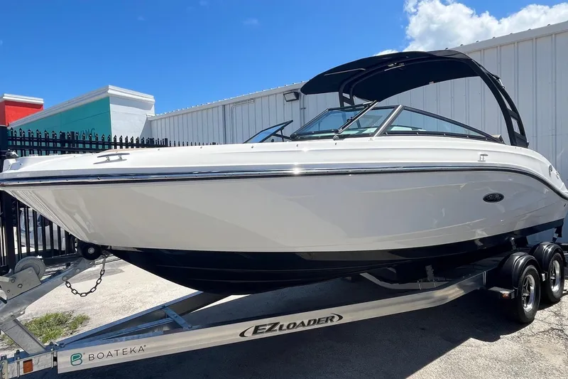 Slide: The Image of 2024 Sea Ray SPX 230 boat on trailer, displayed outdoors under clear blue sky. - 3