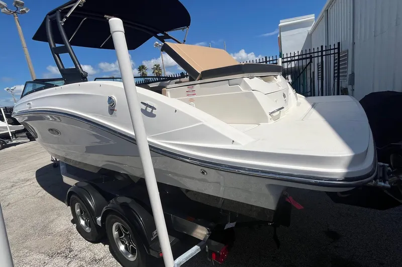 Slide: The Image of 2024 Sea Ray SPX 230 boat on trailer, white exterior, parked outdoors. - 4