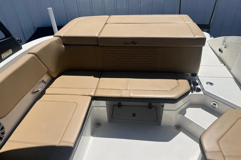 Slide: The Image of 2024 Sea Ray SPX 230 boat interior with tan leather seating and storage compartments. - 6