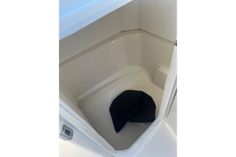 Slide: The Image of 2024 Sea Ray SPX 230 storage compartment with a dark cushion inside. - 7