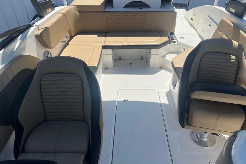 Slide: The Image of 2024 Sea Ray SPX 230 boat interior with tan seating and modern design. - 9