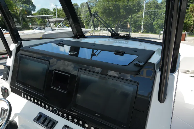 Slide: The Image of 2025 Fountain 32 NX boat dashboard with dual screens and control panel. - 15