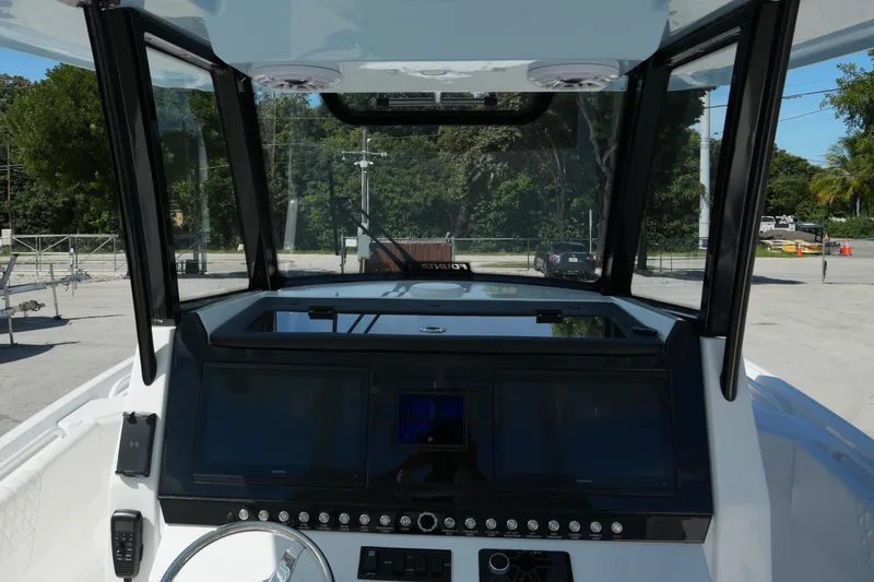 Slide: The Image of 2025 Fountain 32 NX boat dashboard with modern controls and navigation screens. - 16