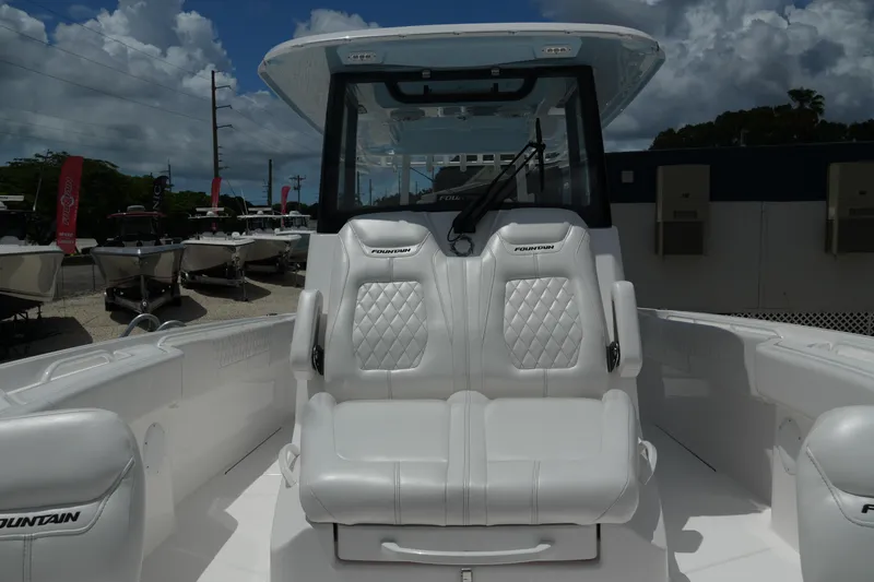 Slide: The Image of 2025 Fountain 32 NX boat interior with luxurious white seating and modern design. - 21