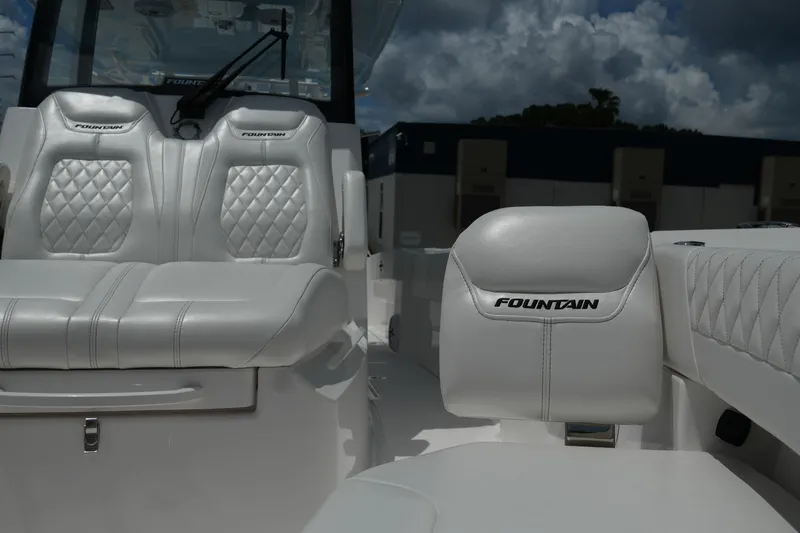 Slide: The Image of 2025 Fountain 32 NX boat interior with luxurious white leather seating and diamond stitching. - 22