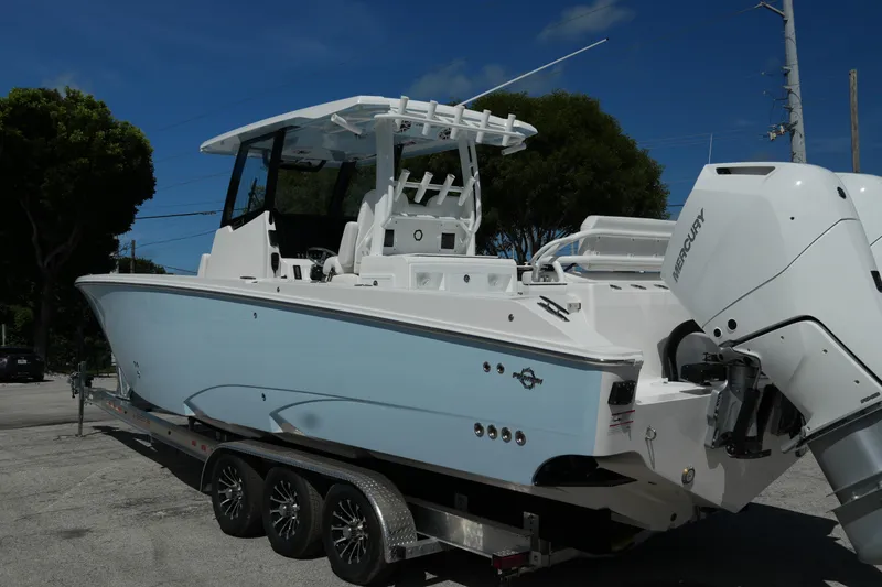 Slide: The Image of 2025 Fountain 32 NX boat on trailer, featuring sleek design and powerful Mercury engines. - 3