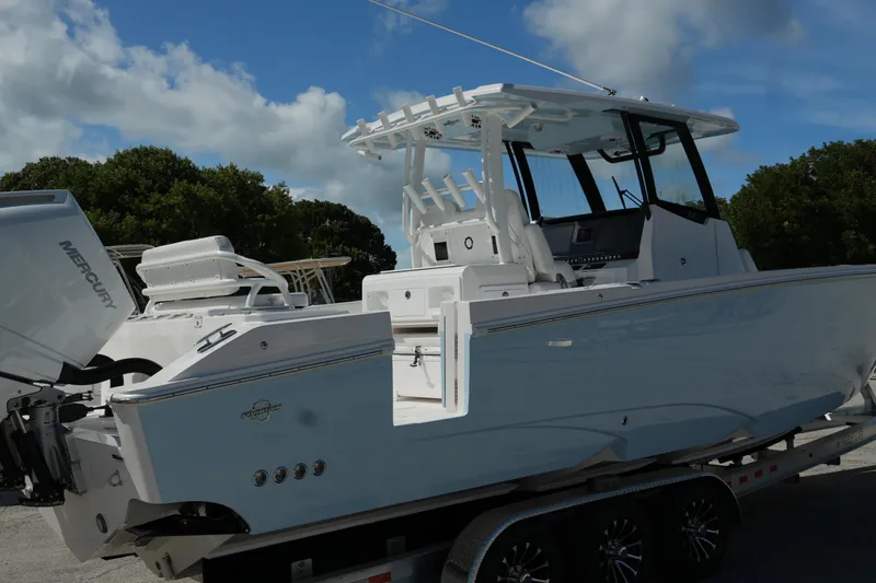 Slide: The Image of 2025 Fountain 32 NX boat on trailer, featuring sleek design and Mercury engine. - 4