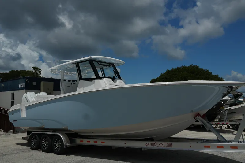 Slide: The Image of 2025 Fountain 32 NX boat on trailer under cloudy sky. - 7