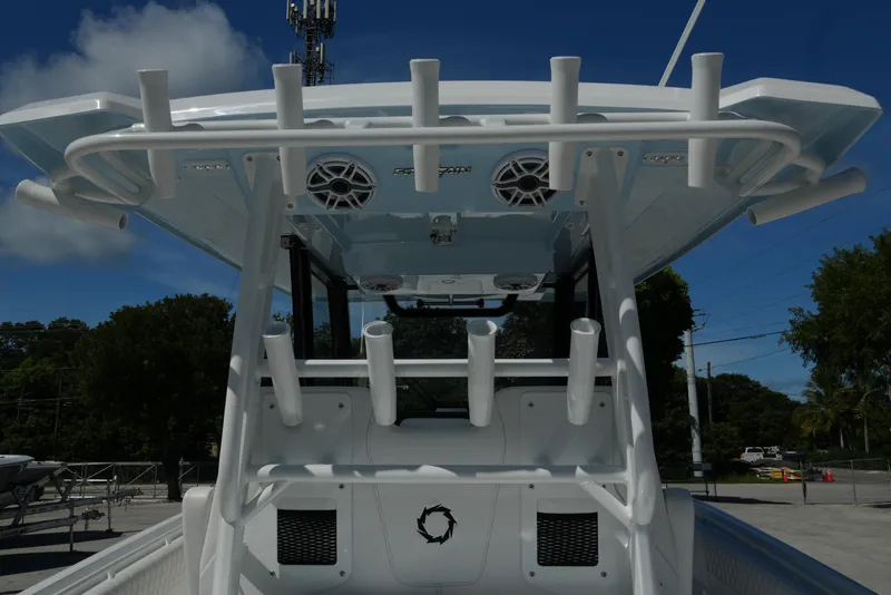 Slide: The Image of 2025 Fountain 32 NX boat with rod holders and speakers under a clear blue sky. - 9