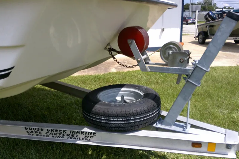 Slide: The Image of Trailer for 2015 KenCraft 2060 BAYRIDER boat with spare tire on grass. - 13