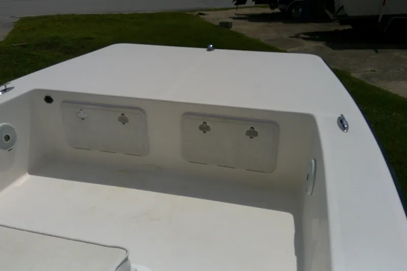 Slide: The Image of 2015 KenCraft 2060 BAYRIDER boat deck with storage compartments, outdoor setting. - 15