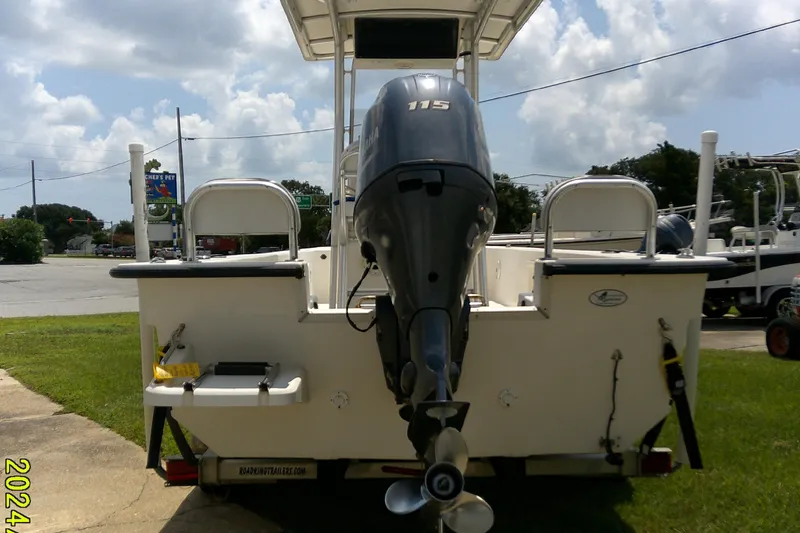 Slide: The Image of 2015 KenCraft 2060 BAYRIDER boat with Yamaha 115 outboard motor, parked outdoors. - 18