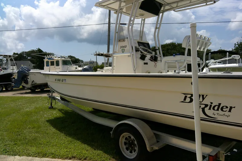 Slide: The Image of 2015 KenCraft 2060 BAYRIDER boat on trailer, parked on grass under cloudy sky. - 23