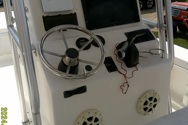 Slide: The Image of Control panel of a 2015 KenCraft 2060 BAYRIDER boat with steering wheel and throttle. - 4