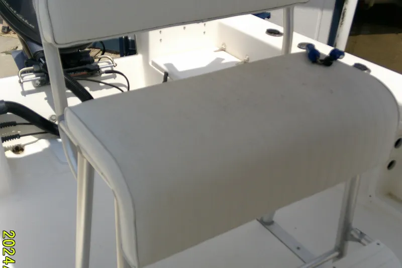 Slide: The Image of 2015 KenCraft 2060 BAYRIDER boat interior with white seating and engine components. - 9