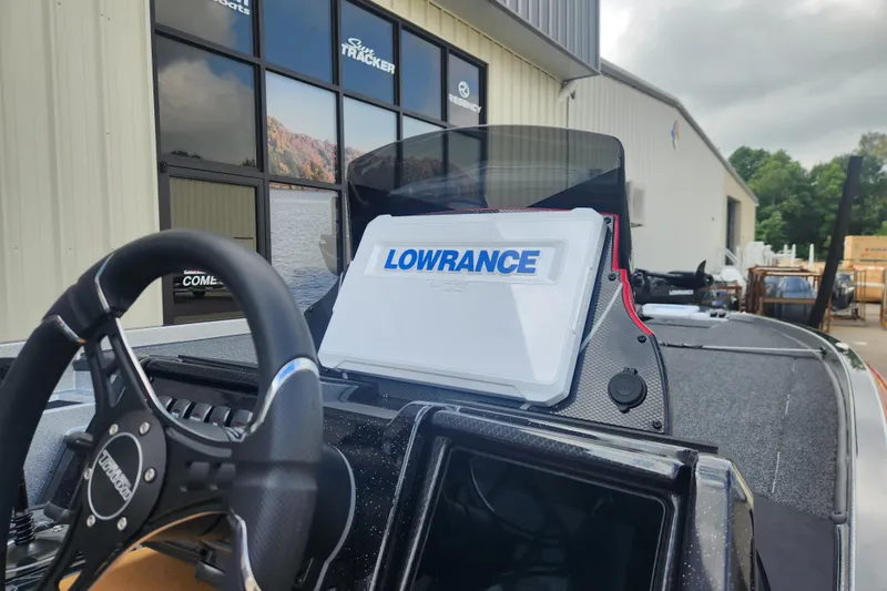 Slide: The Image of 2025 Triton 20XP Patriot boat with Lowrance navigation system, parked outside a dealership. - 11