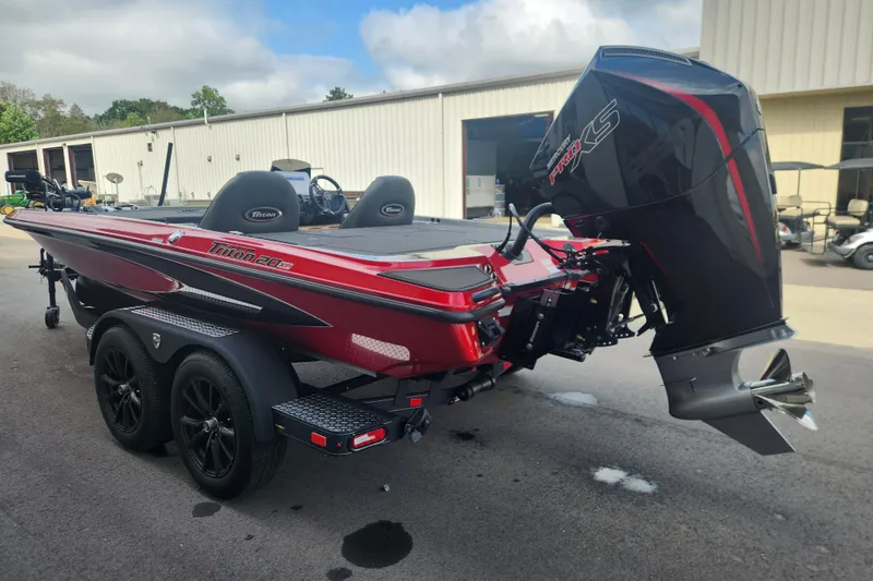 Slide: The Image of 2025 Triton 20XP Patriot boat with powerful outboard motor, parked on a trailer. - 3