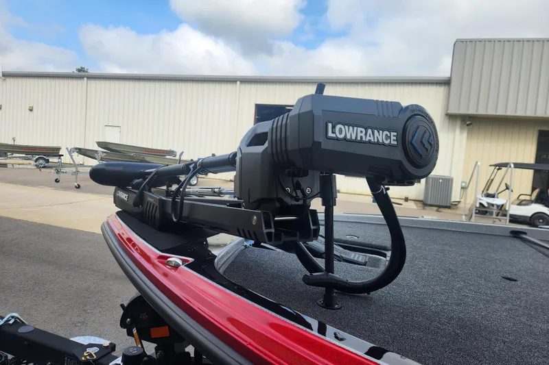 Slide: The Image of Triton 20XP Patriot 2025 boat with Lowrance equipment, parked outdoors. - 7