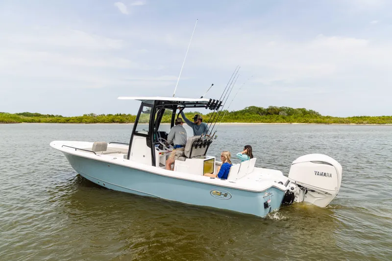 Slide: The Image of 2026 Sea Hunt BX 25 FS boat on water with passengers, featuring Yamaha engine. - 10