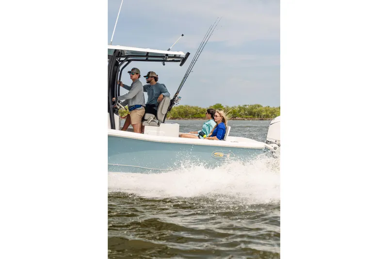 Slide: The Image of 2026 Sea Hunt BX 25 FS boat cruising with passengers on a sunny day. - 9