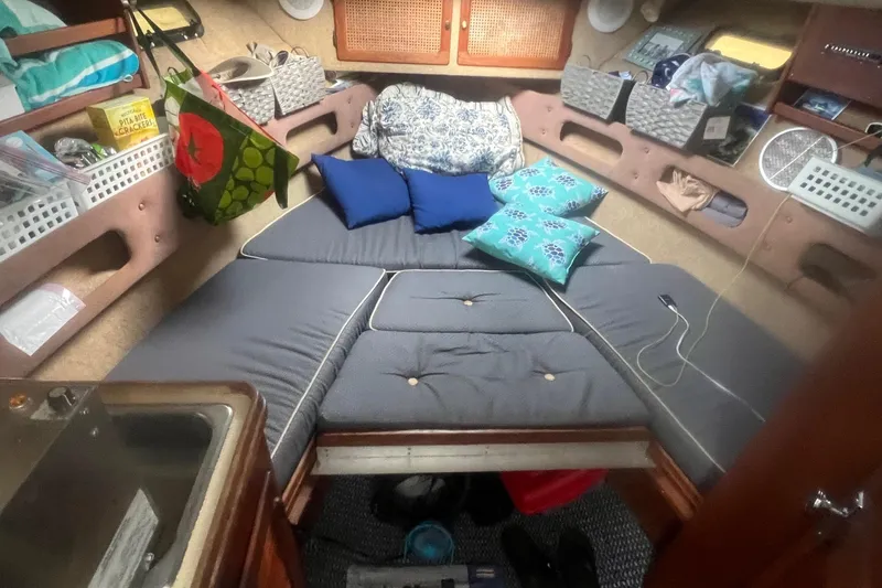 Slide: The Image of Cozy cabin interior of a 1984 Tiara 2700 boat with cushions and storage. - 11