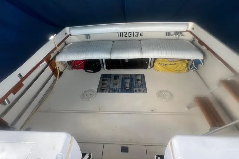 Slide: The Image of 1984 Tiara 2700 boat interior with seating, storage, and nautical equipment. - 7