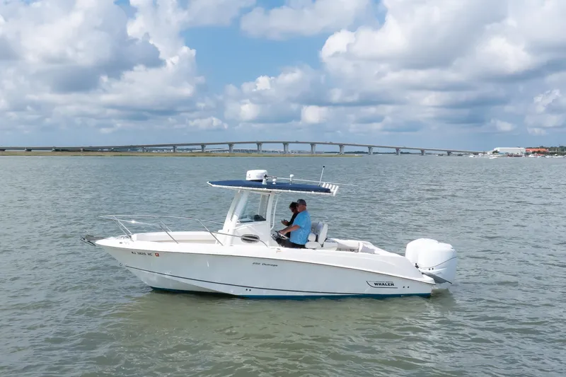 Slide: The Image of 2010 Boston Whaler 250 Outrage boat cruising on open water, featuring twin 225 Mercury Verado engines with 455 hours - 22