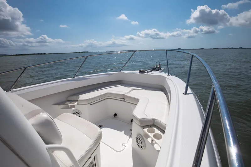 Slide: The Image of 2010 Boston Whaler 250 Outrage boat on water, featuring twin engines and spacious deck. - 24