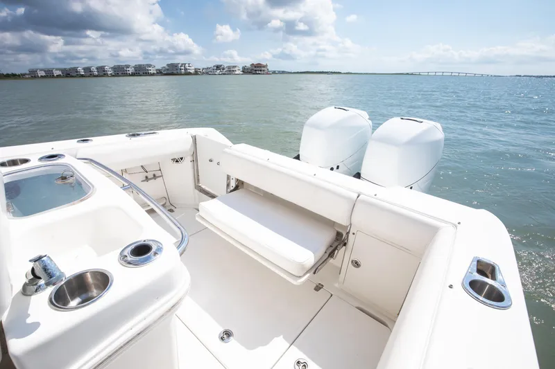 Slide: The Image of 2010 Boston Whaler 250 Outrage boat with twin engines, livewell, tackle center and aft seating. - 28