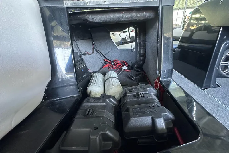 Slide: The Image of 2014 Axis A24 boat interior showing battery compartment and wiring setup. - 18
