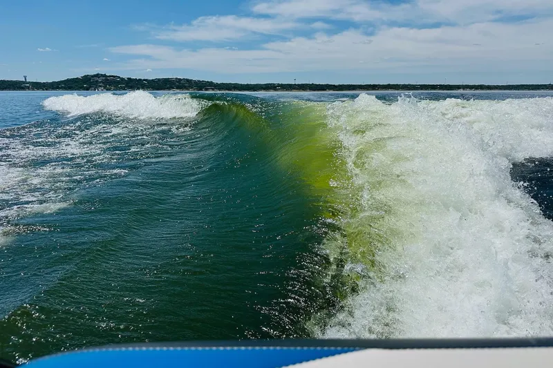 Slide: The Image of Wake created by a 2014 Axis A24 boat on a sunny lake day. - 22