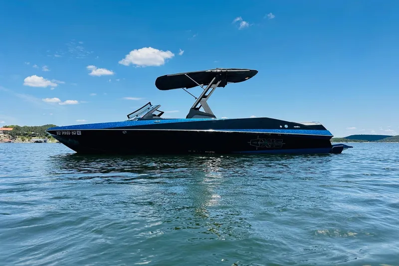 Slide: The Image of 2014 Axis A24 boat on calm water under clear blue sky. - 3