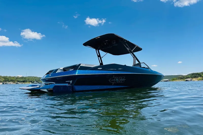 Slide: The Image of 2014 Axis A24 boat on a sunny lake with clear blue skies. - 4