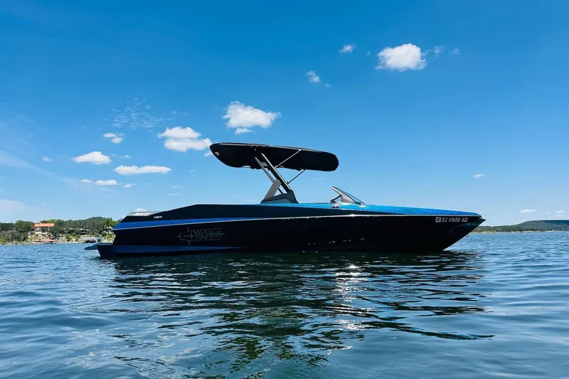 Slide: The Image of 2014 Axis A24 boat on a sunny lake with clear blue skies. - 5