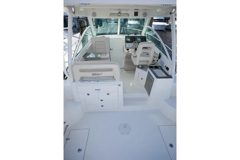 Slide: The Image of 2019 Boston Whaler 315 Conquest boat interior with helm and seating area. - 30