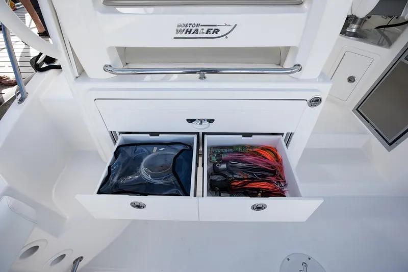 Slide: The Image of 2019 Boston Whaler 315 Conquest boat interior with helm and seating area. - 31