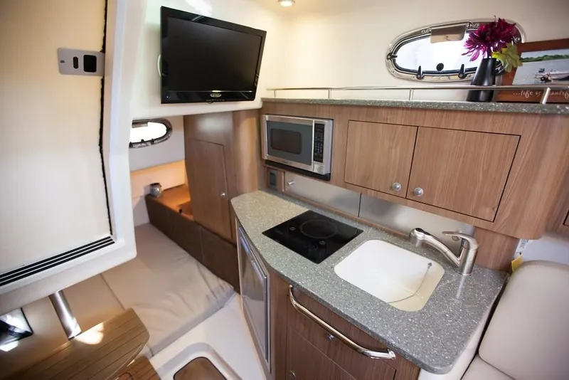 Slide: The Image of 2019 Boston Whaler 315 Conquest storage drawers with organized equipment. - 32