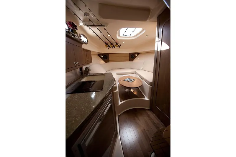 Slide: The Image of 2019 Boston Whaler 315 Conquest cabin kitchen with microwave, sink, and TV. - 33