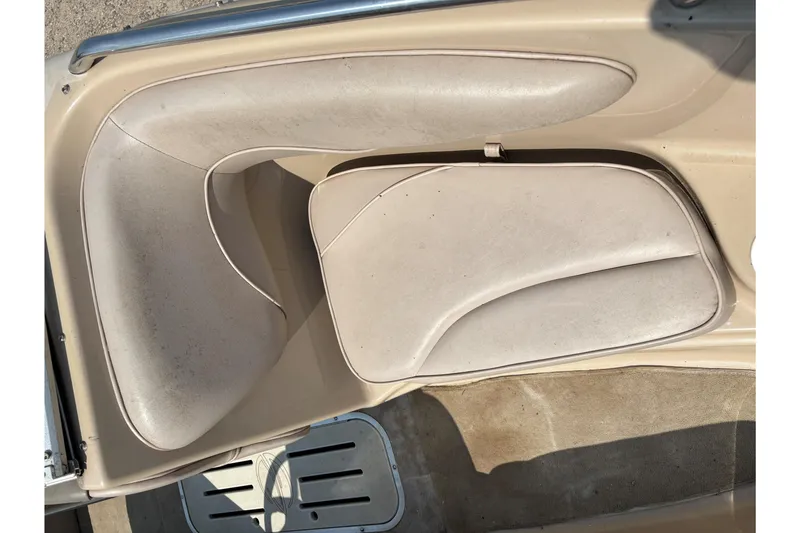 Slide: The Image of 2001 Crownline 18' boat interior with beige seating and carpeted flooring. - 10