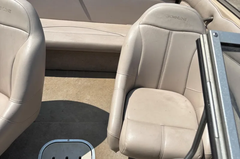 Slide: The Image of Interior of a 2001 Crownline 18' boat with beige seating. - 15