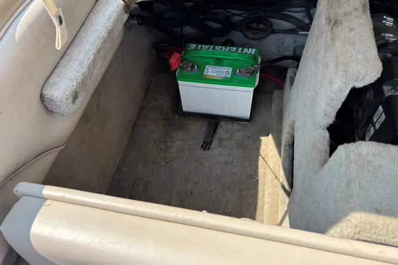 Slide: The Image of Interior of a 2001 Crownline 18' boat showing a battery compartment. - 17