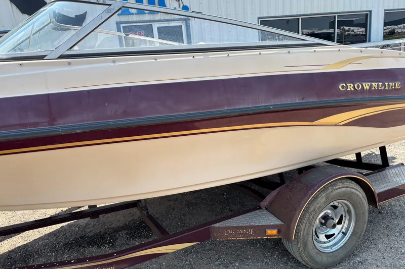 Slide: The Image of 2001 Crownline 18' boat on trailer, maroon and cream color scheme. - 2