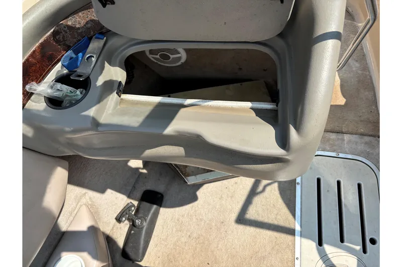 Slide: The Image of Interior of a 2001 Crownline 18' boat showing storage compartment and cup holder. - 20