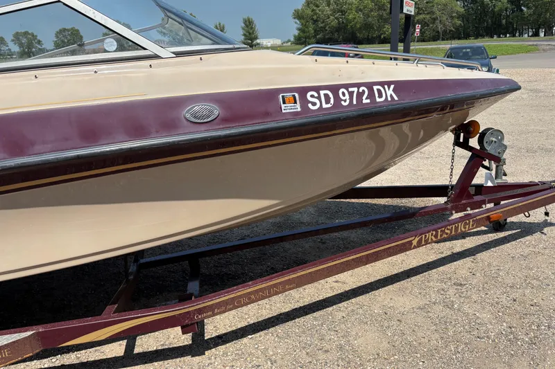 Slide: The Image of 2001 Crownline 18' boat on Prestige trailer, parked on gravel. - 6